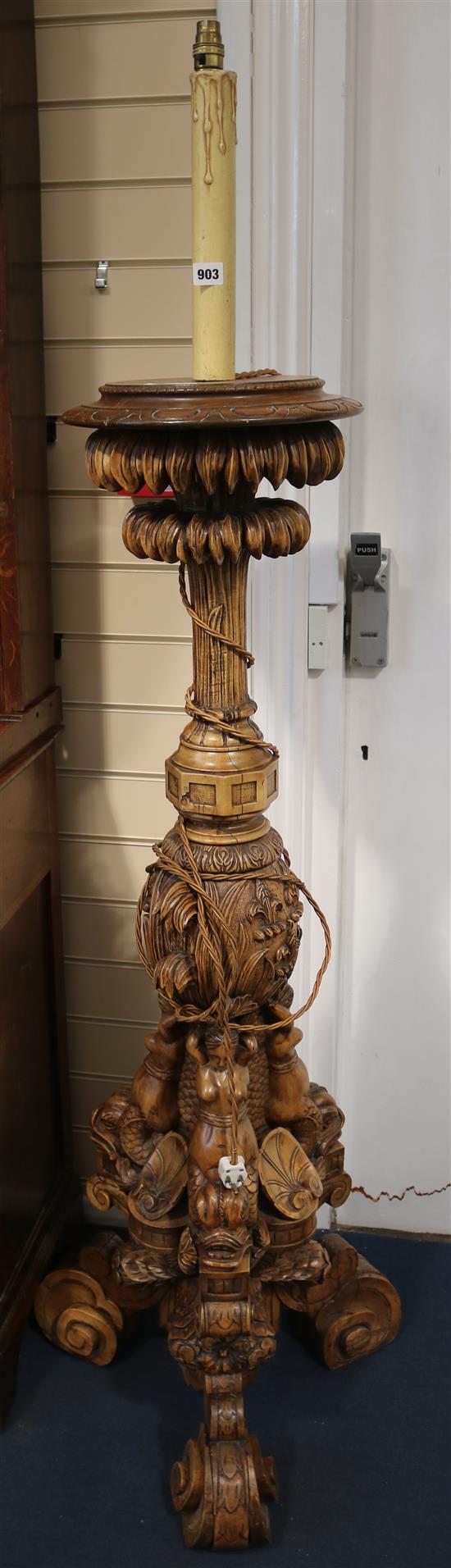 A 17th century style Florentine design carved walnut torchere, 177cm high